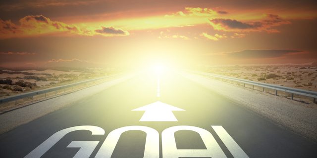 Goal word and arrow on a road - destination concept